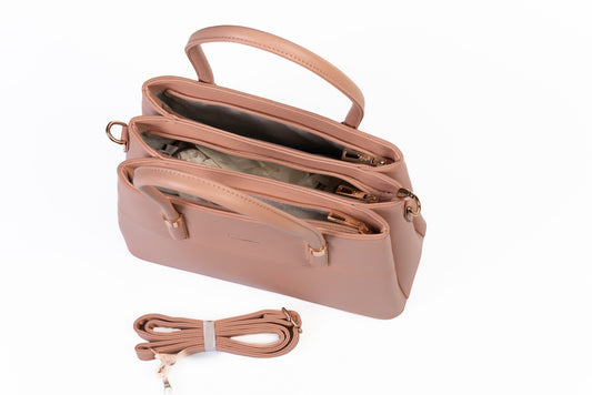 siddhata pink medium PU leather handbag with dual compartments, sturdy handles, and a detachable shoulder strap.
